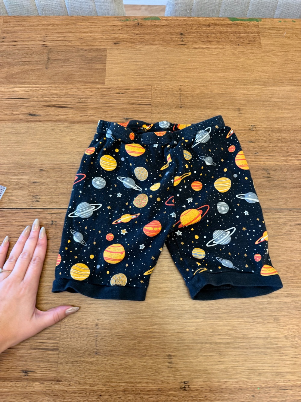 Size 6 Black Planet Print Shorts with Orange and Yellow Planets and Gray Rings